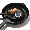 No.5 Skillet shown nestled inside No.10 skillet with our metal scrubber, wooden brush, and seasoning oil. thumbnail
